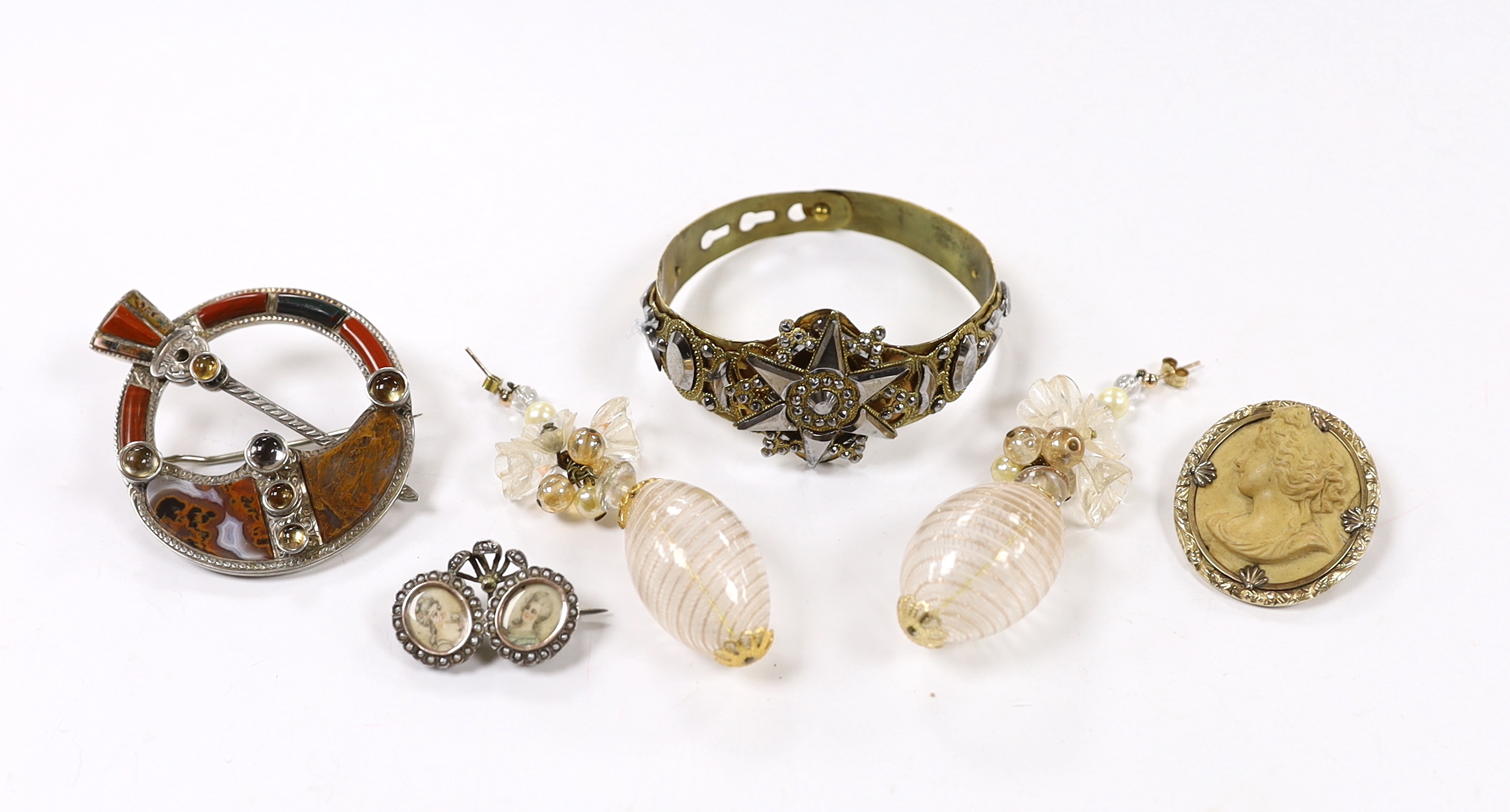 A small collection of assorted jewellery including a lava brooch, Scottish hardstone and cabochon set white metal brooch, pair of Venetian? glass drop earrings, two tone cut steel bangle and a white metal and simulated s